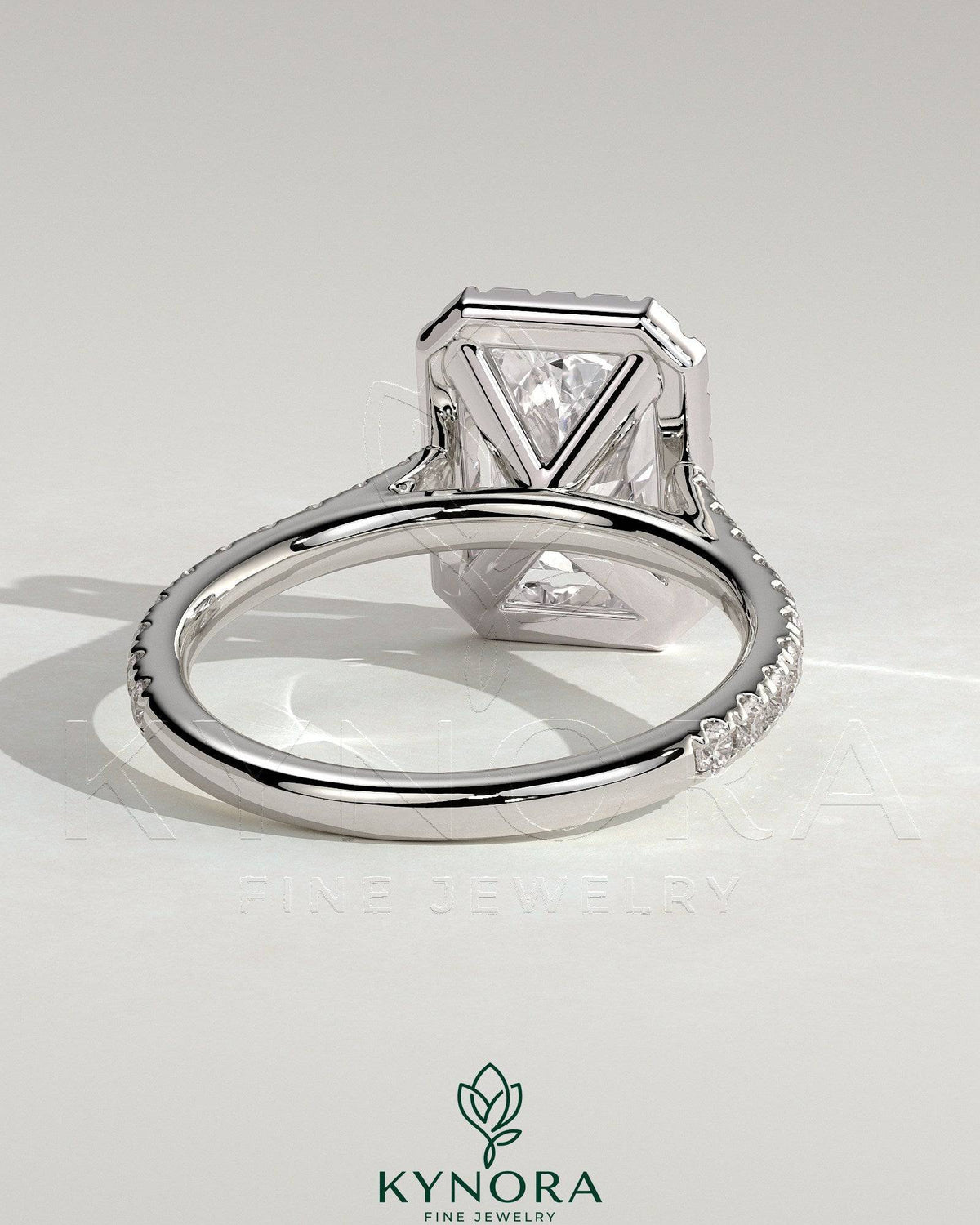 Kynora CJ 2ct radiant diamond claw solitaire engagement ring with halo, pave band, and cathedral high setting.