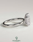 Kynora CJ 1.8ct emerald and 1.5ct pear-shaped Toi et Moi engagement ring with hidden halo and intricate detailing.