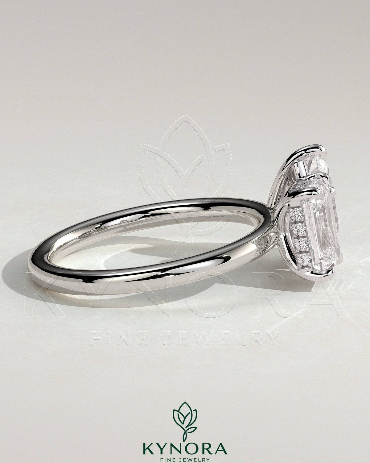 Kynora CJ 1.8ct emerald and 1.5ct pear-shaped Toi et Moi engagement ring with hidden halo and intricate detailing.