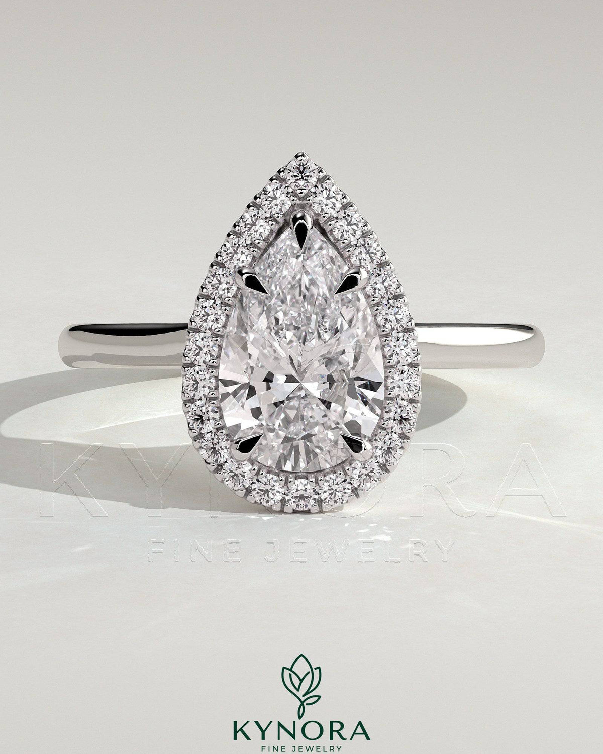 Kynora CJ 2ct pear-shaped diamond solitaire halo engagement ring with cathedral high setting, elegant and sparkling jewelry piece.