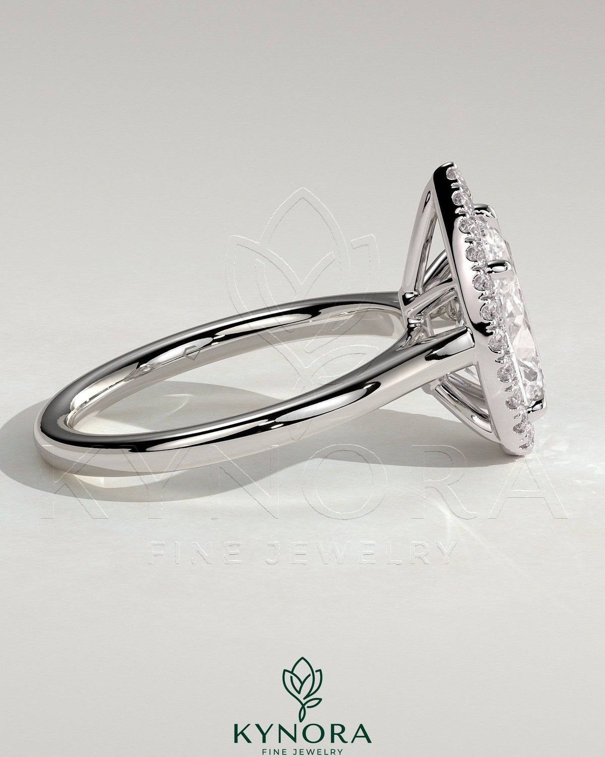 Kynora CJ 2ct pear-shaped diamond halo solitaire engagement ring with cathedral high setting and intricate band details.