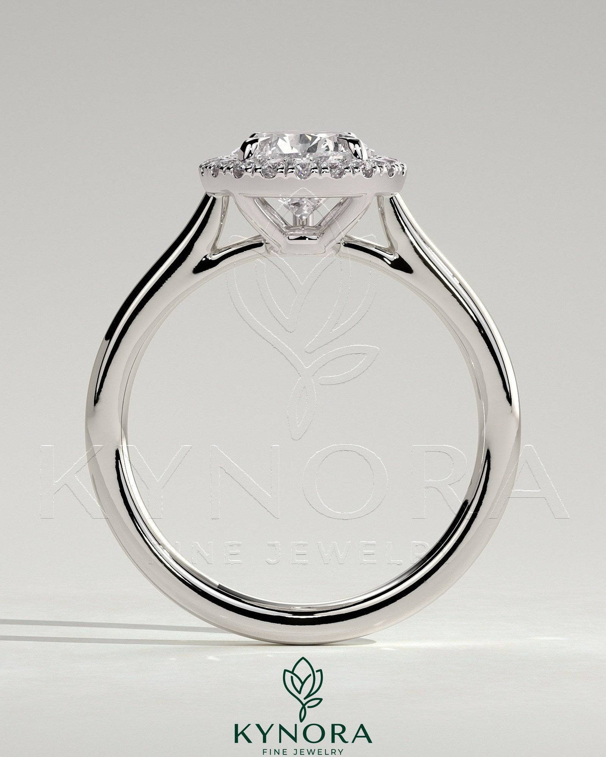 Kynora CJ 2ct pear-shaped diamond solitaire engagement ring with halo and cathedral high setting, showcasing intricate design details.