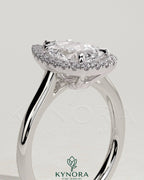 Kynora CJ 2ct pear-shaped diamond solitaire engagement ring with halo and cathedral high setting, showcasing intricate design details.
