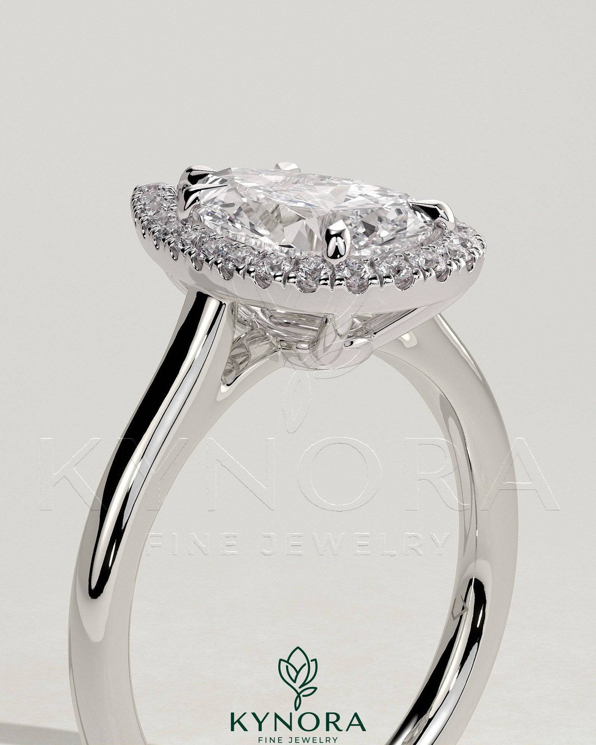 Kynora CJ 2ct pear-shaped diamond solitaire engagement ring with halo and cathedral high setting, showcasing intricate design details.