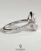 Kynora CJ 2ct pear-shaped diamond solitaire halo engagement ring with pave band and low setting, elegant jewelry design