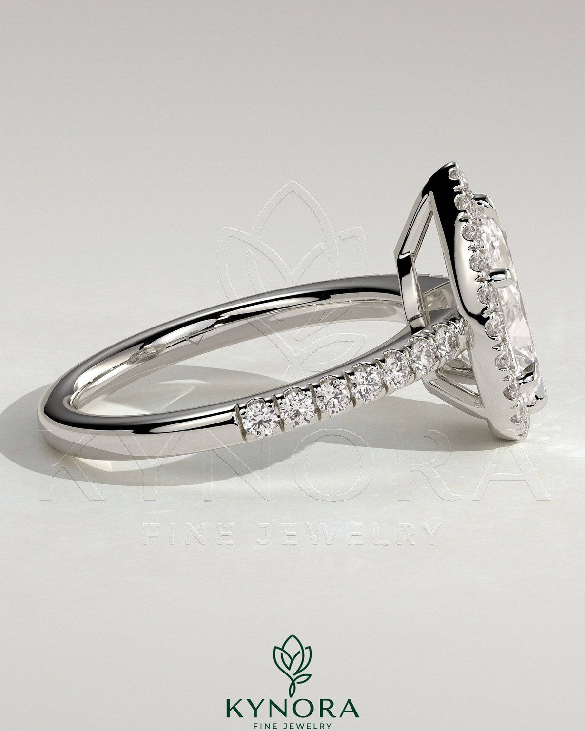 Kynora CJ 2ct pear-shaped diamond solitaire halo engagement ring with pave band and low setting, elegant jewelry design