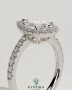 Kynora CJ 2ct pear-shaped diamond solitaire halo engagement ring with pave band and low setting, elegant and sparkling.