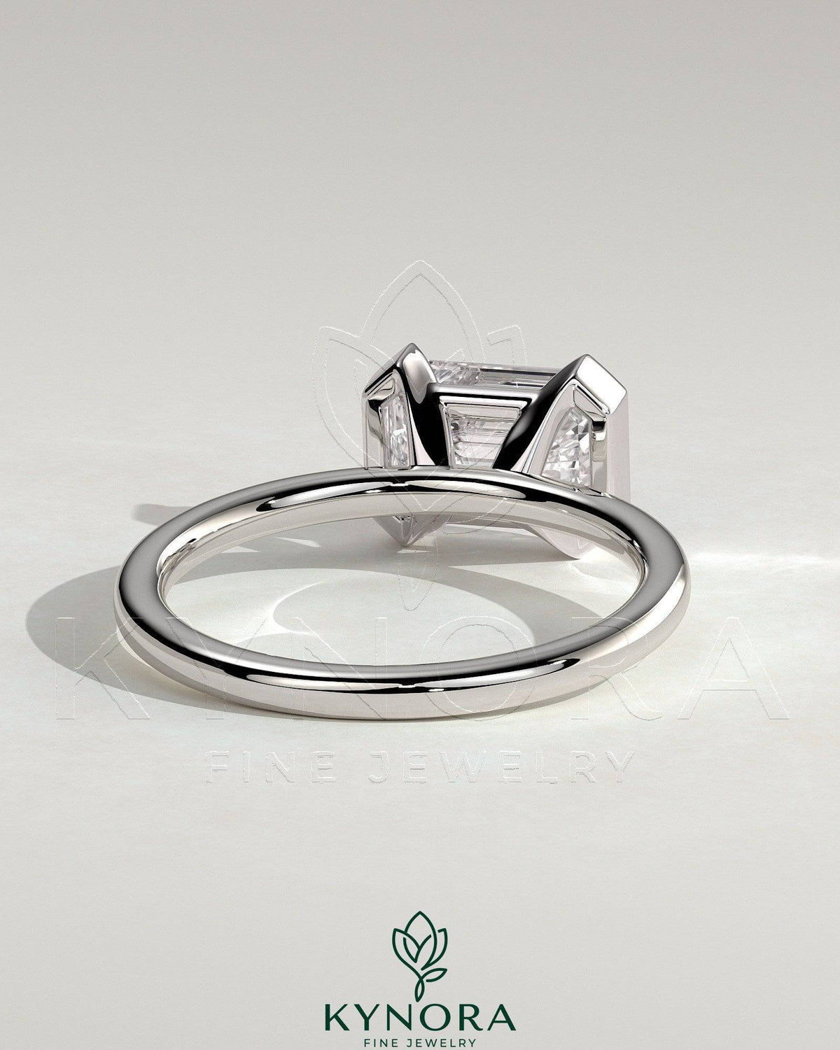 Kynora CJ 2ct emerald cut east-west half bezel solitaire engagement ring with a sleek design and sparkling gemstone.