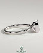Kynora CJ 2ct emerald cut east-west bezel solitaire engagement ring with a sleek band and detailed craftsmanship.