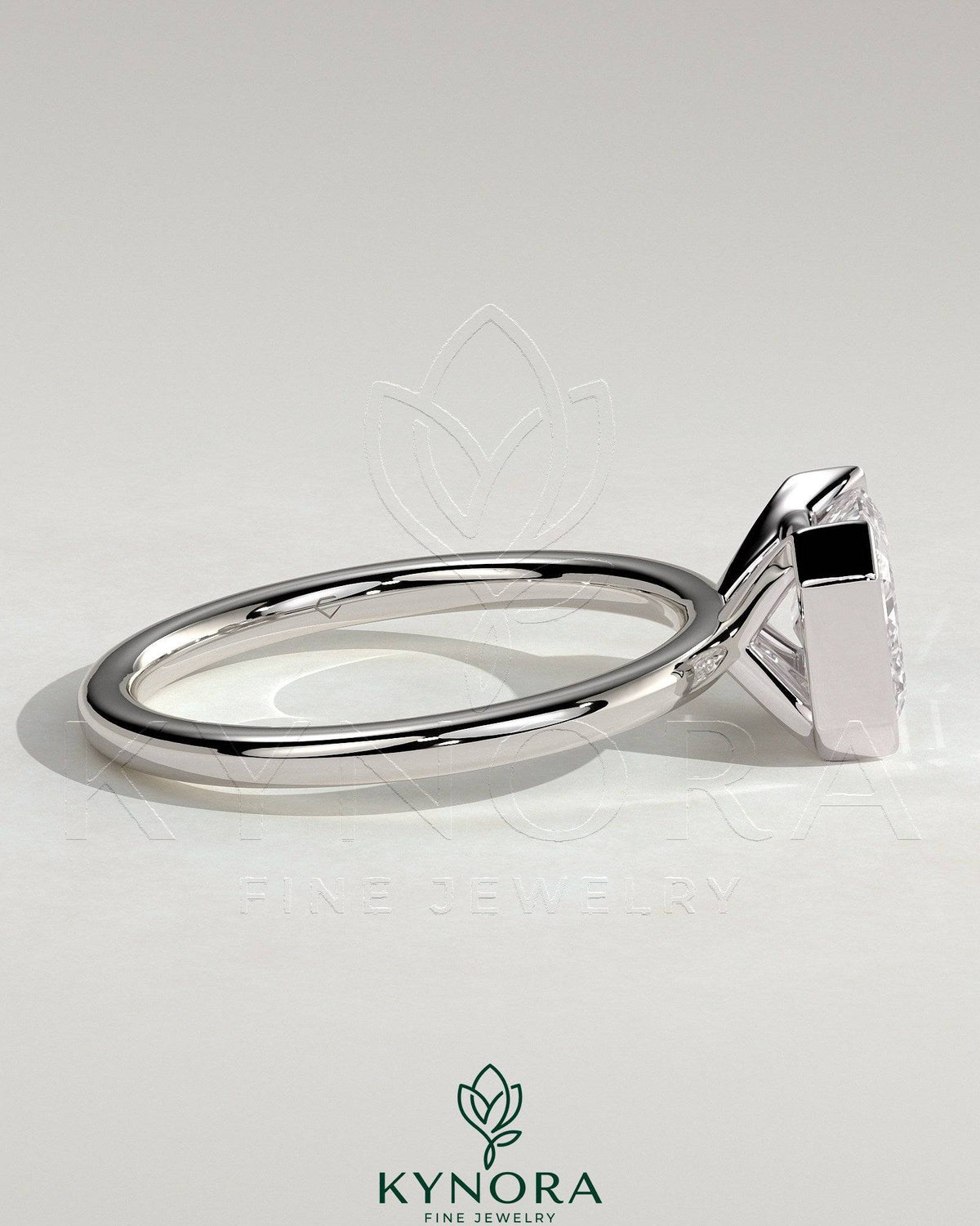 Kynora CJ 2ct emerald cut east-west bezel solitaire engagement ring with a sleek band and detailed craftsmanship.