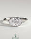 East-West 2-carat oval bezel solitaire engagement ring by Kynora CJ featuring a prominent oval diamond set horizontally on a sleek band