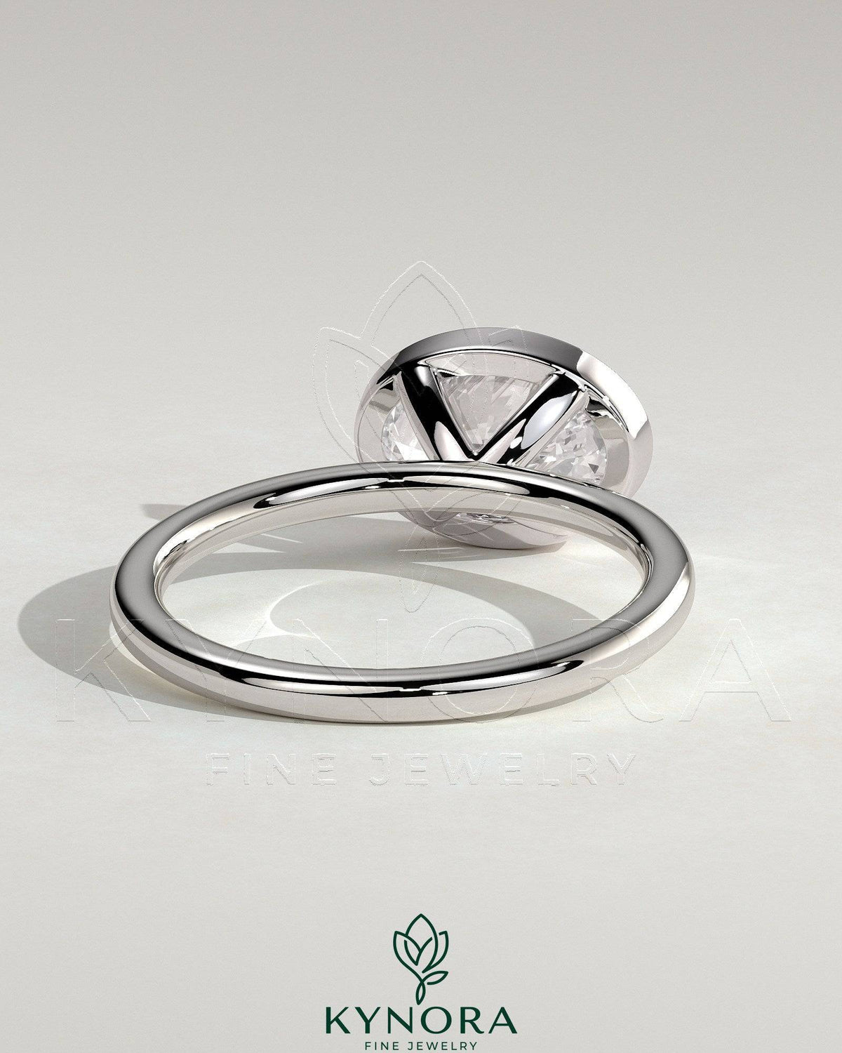 Kynora CJ 2ct oval east-west bezel solitaire engagement ring featuring a central gemstone and sleek band design.