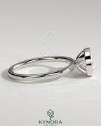 Kynora CJ 2ct oval east-west bezel solitaire engagement ring with a prominent center diamond and sleek band design.