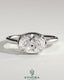 Kynora CJ 2ct oval east-west claw solitaire engagement ring with bezel frame, showcasing a sparkling central diamond on a sleek band.