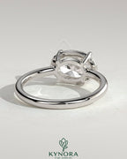 Kynora CJ 2ct oval east-west claw solitaire engagement ring with bezel frame, showcasing a sparkling center stone and elegant design.