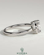 Kynora CJ 2ct oval east-west claw solitaire engagement ring with bezel frame, showcasing a sparkling diamond on a sleek band.