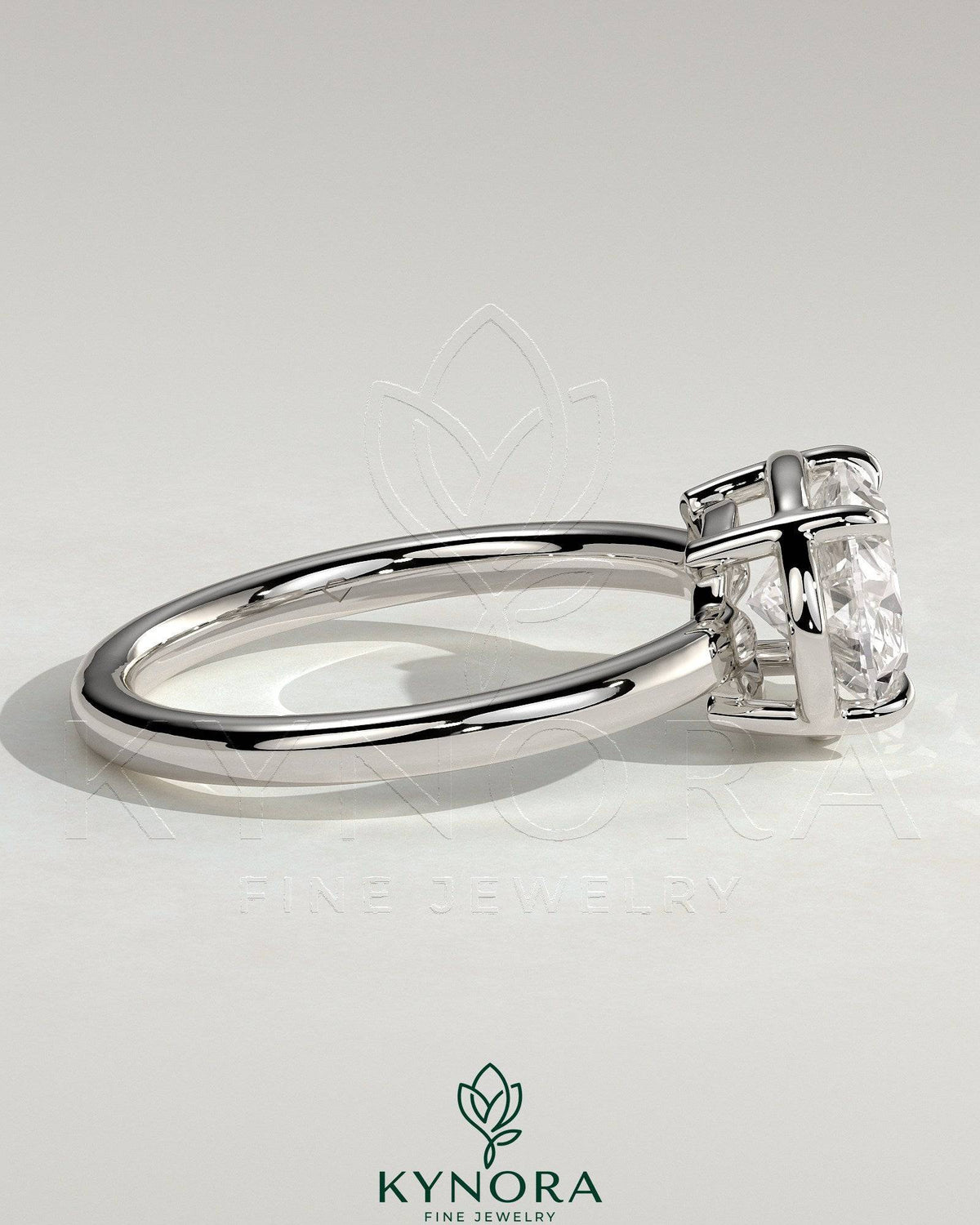 Kynora CJ 2ct oval east-west claw solitaire engagement ring with bezel frame, showcasing a sparkling diamond on a sleek band.