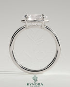 Kynora CJ 2ct oval east-west claw solitaire engagement ring with bezel frame showcasing a sparkling diamond on a silver band