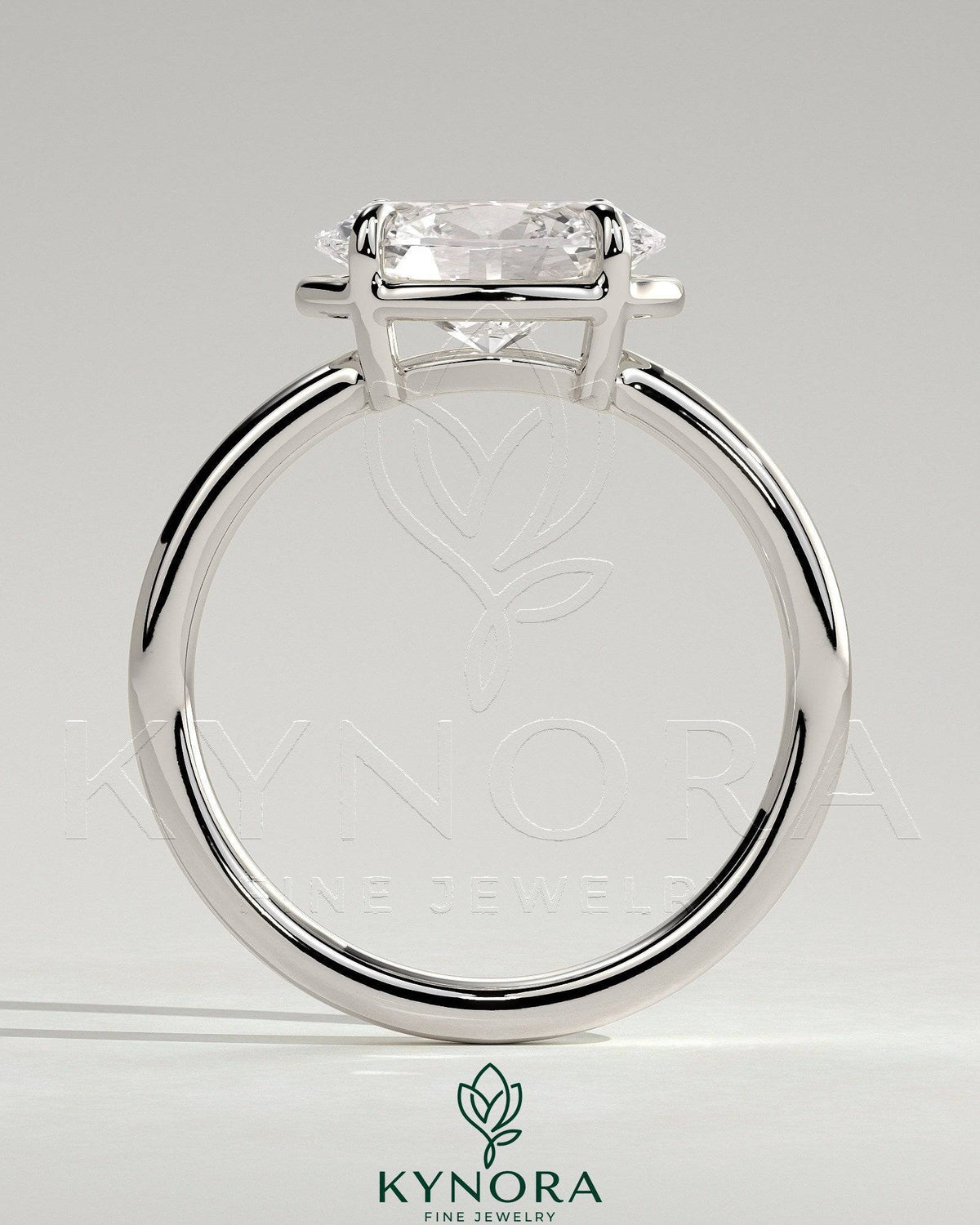Kynora CJ 2ct oval east-west claw solitaire engagement ring with bezel frame showcasing a sparkling diamond on a silver band