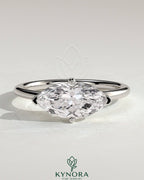 Kynora CJ 2ct marquise east-west claw solitaire engagement ring with raised basket gallery and intricate metalwork.