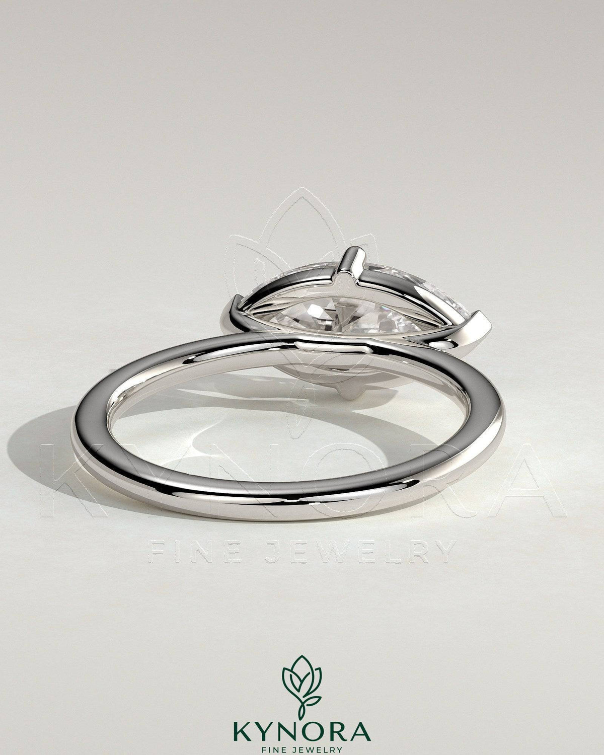 Kynora CJ 2ct marquise east-west claw solitaire engagement ring with raised basket gallery, showcasing elegant diamond setting.
