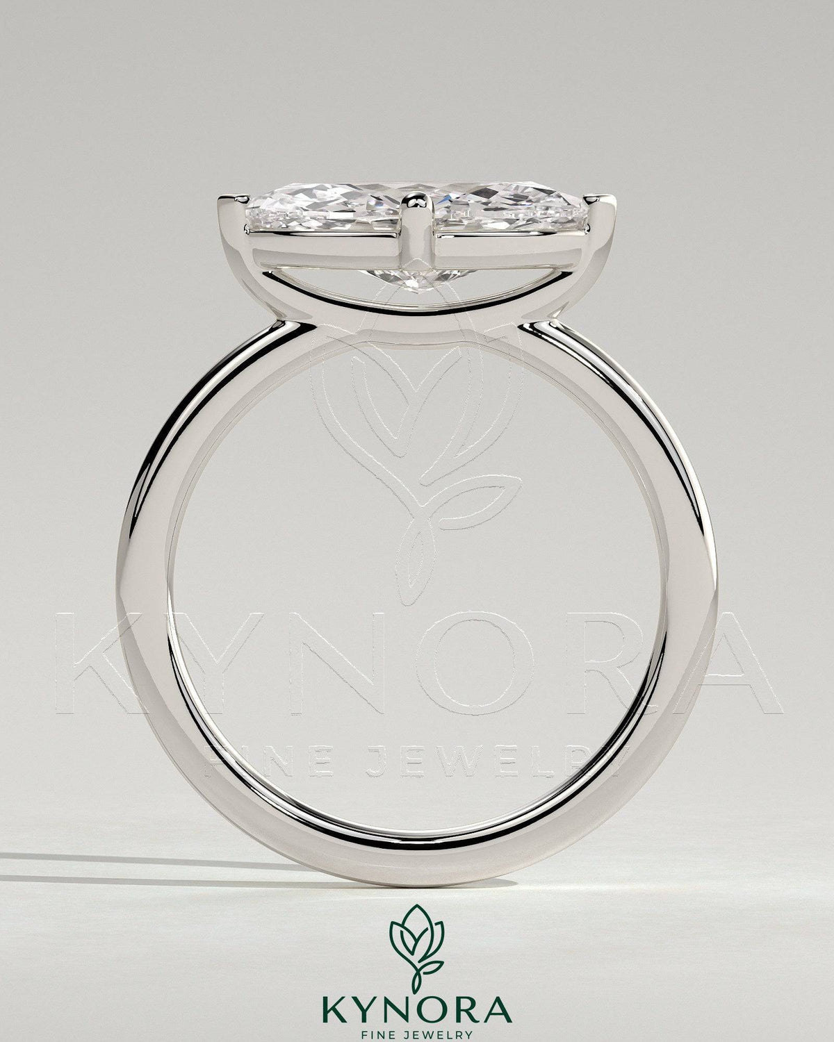 Kynora CJ 2ct marquise east-west claw solitaire engagement ring with raised basket gallery featuring a sparkling diamond.