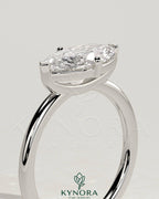 Kynora CJ 2ct marquise east-west claw solitaire engagement ring with raised basket gallery showcasing elegant jewelry design.