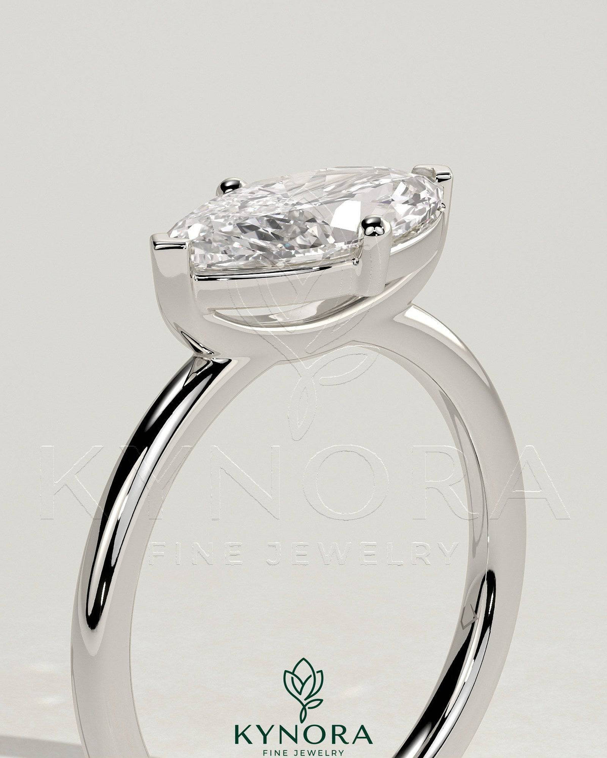 Kynora CJ 2ct marquise east-west claw solitaire engagement ring with raised basket gallery showcasing elegant jewelry design.