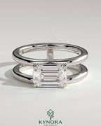 Kynora CJ 2ct emerald east-west claw solitaire engagement ring with a double band and spaced design.