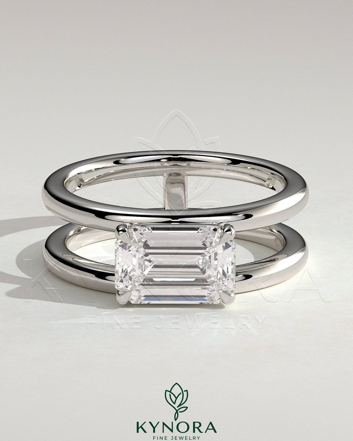 Kynora CJ 2ct emerald east-west claw solitaire engagement ring with a double band and spaced design.