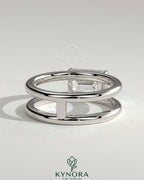Kynora CJ 2ct emerald east-west claw solitaire engagement ring with spaced double band, showcasing a vibrant green emerald and elegant design.