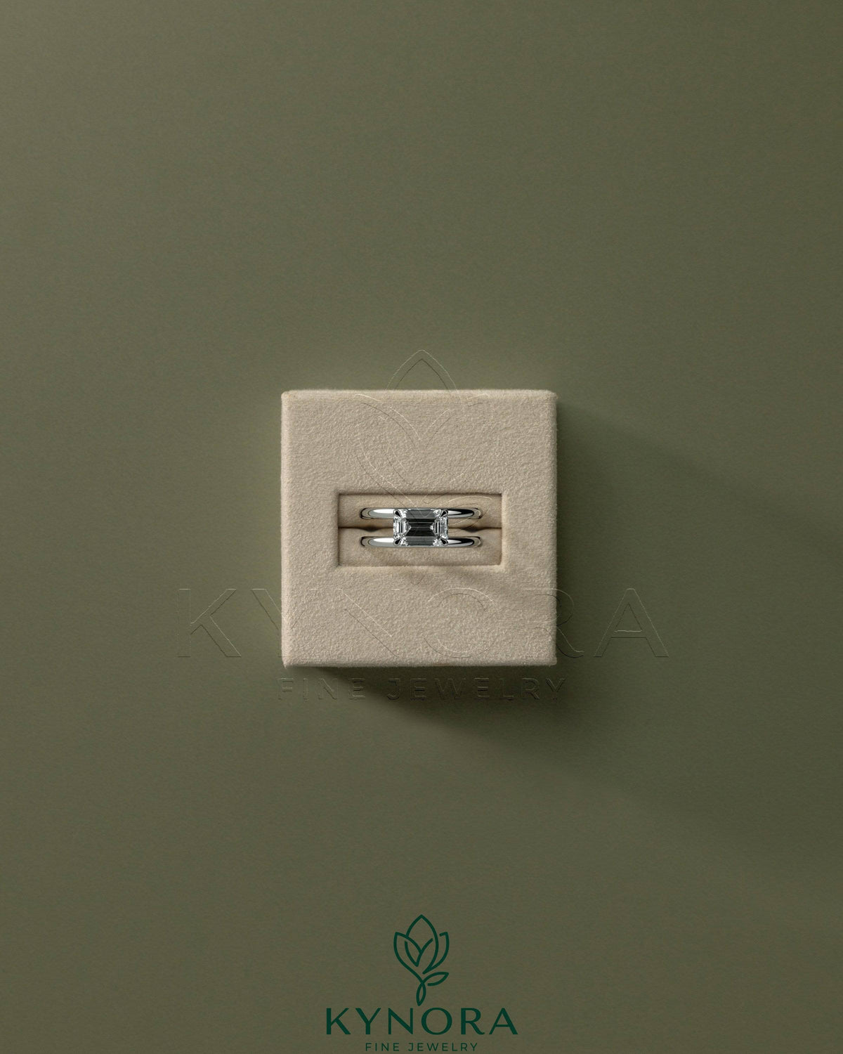Kynora CJ 2ct emerald east-west claw solitaire engagement ring with spaced double band in silver or white gold.