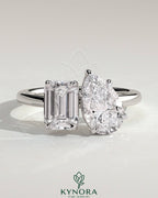 Kynora CJ 1.8ct emerald and 1.5ct pear-shaped diamonds Toi et Moi engagement ring with hidden halo and claw setting.