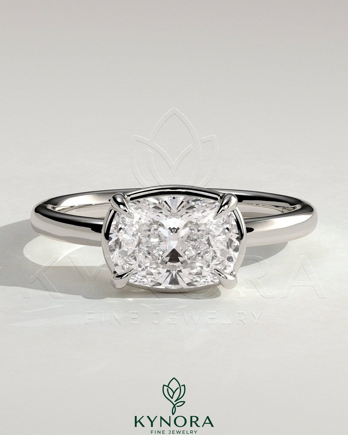 Kynora CJ 2ct elongated cushion cut East-West claw solitaire engagement ring with bezel frame showcasing a sparkling diamond.