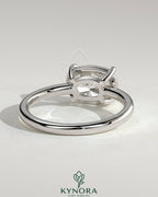 Kynora CJ 2ct elongated cushion cut diamond engagement ring with east-west setting and bezel frame.
