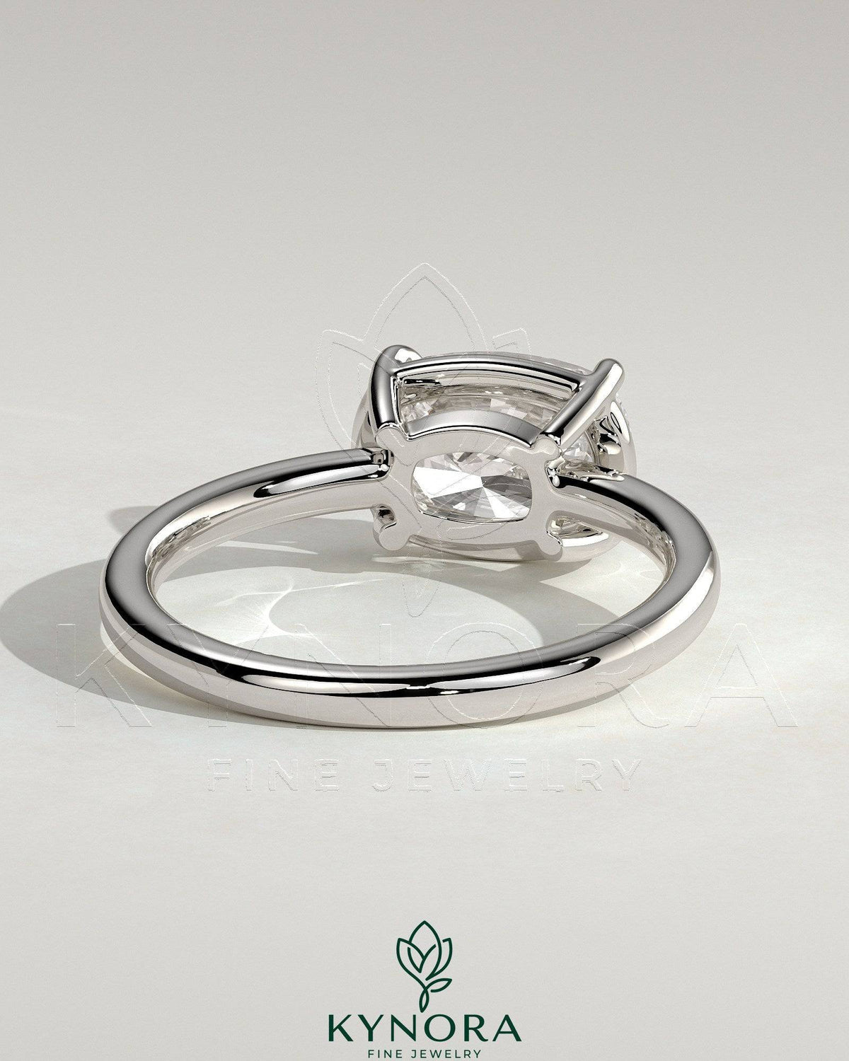 Kynora CJ 2ct elongated cushion cut diamond engagement ring with east-west setting and bezel frame.
