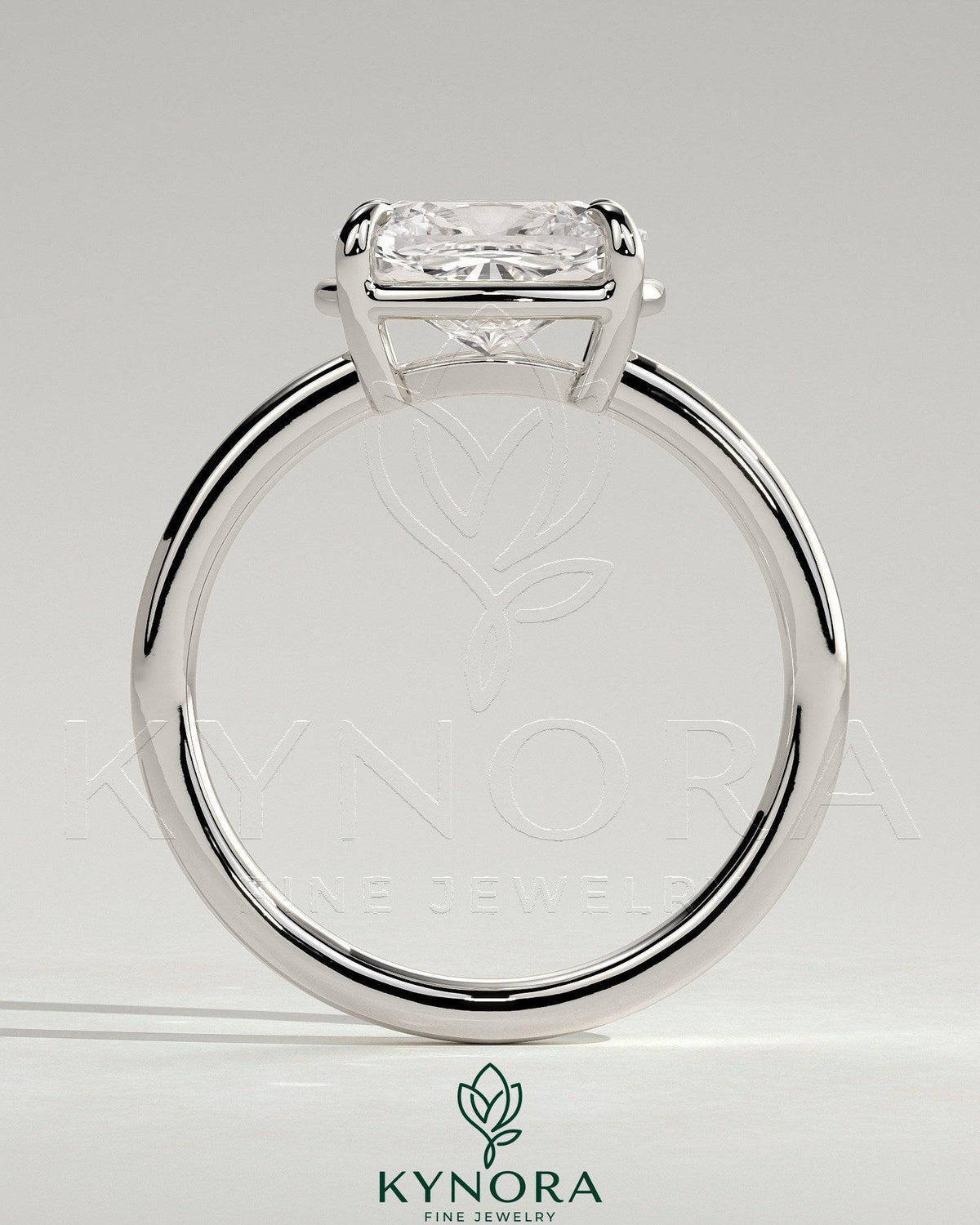 Kynora CJ 2ct elongated East-West cushion claw solitaire engagement ring with bezel frame, showcasing elegant diamond setting.