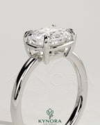 Kynora CJ 2ct elongated cushion East-West claw solitaire engagement ring with bezel frame, featuring a sparkling central diamond.