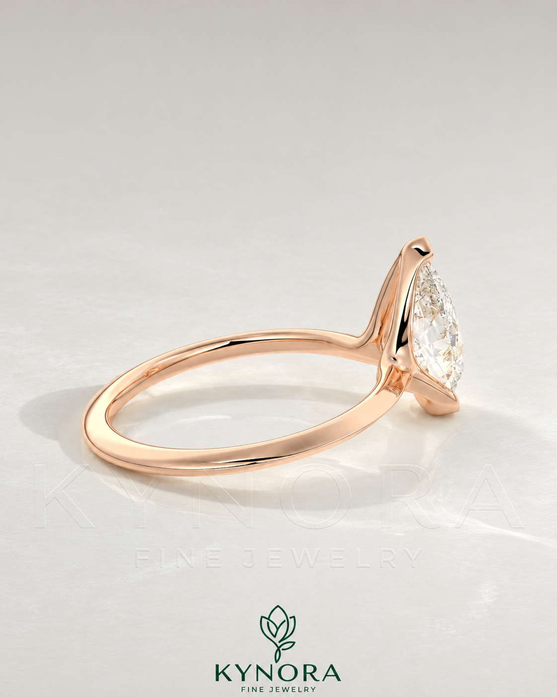 Pear cut moissanite half-bezel engagement ring in 925 silver featuring a detailed textured band and secure stone setting.