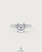 Sterling silver solitaire engagement ring with cushion cut moissanite gemstone, featuring a sleek and elegant design by Kynora CJ.