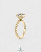 Round moissanite solitaire engagement ring with twisted silver shank by Kynora CJ, showcasing a sparkling center stone and intricate band details.