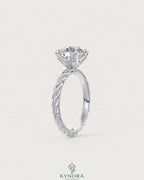 Round moissanite solitaire engagement ring with twisted shank in 925 silver, showcasing elegant craftsmanship and sparkling gemstone.