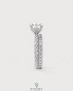 Round moissanite solitaire engagement ring with twisted silver shank by Kynora CJ, showcasing a sparkling center stone and intricate band design.