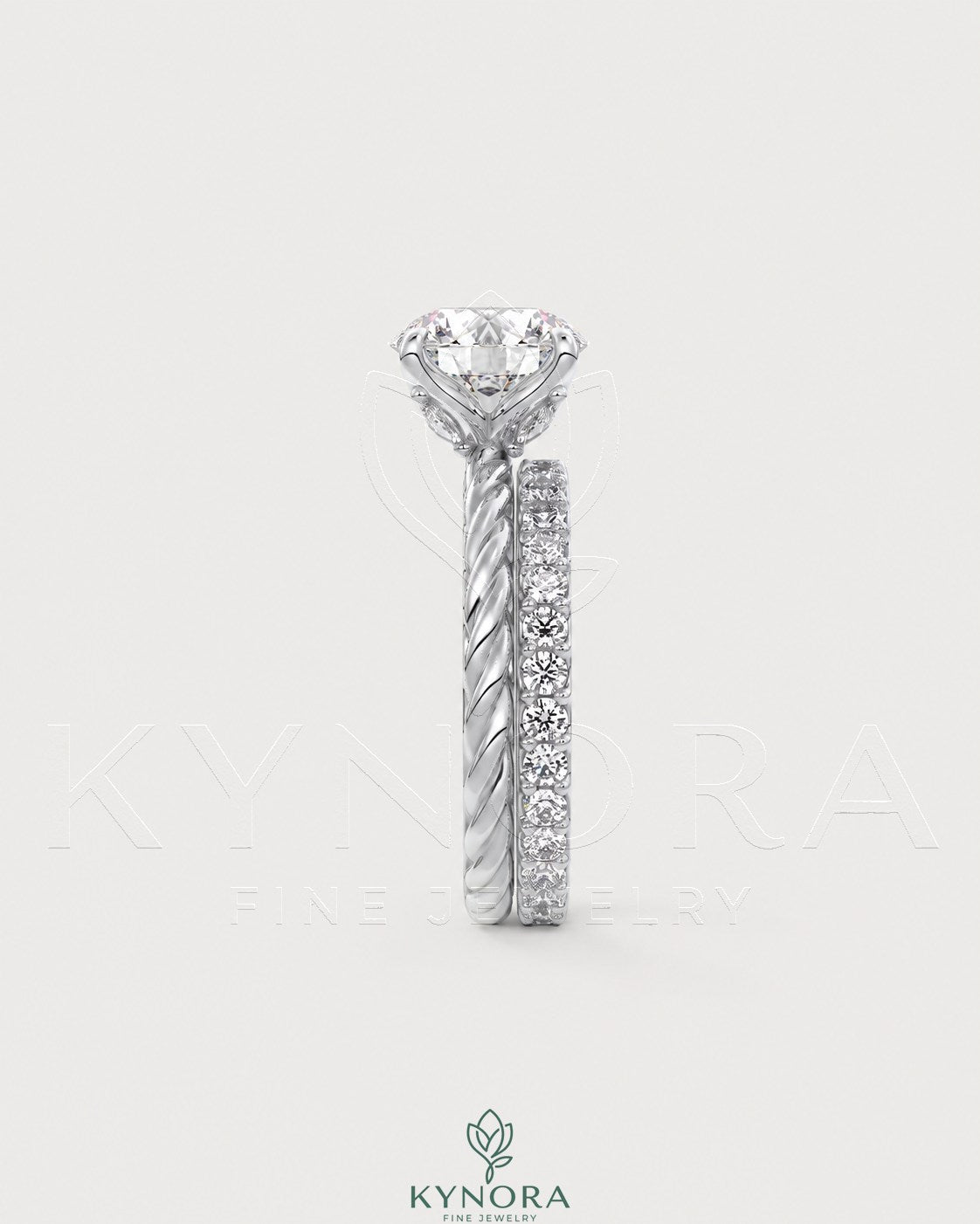 Round moissanite solitaire engagement ring with twisted silver shank by Kynora CJ, showcasing a sparkling center stone and intricate band design.