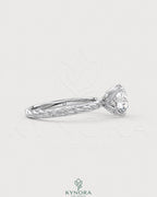 Round moissanite solitaire engagement ring with twisted silver shank, crafted by Kynora CJ, featuring a sparkling central stone.