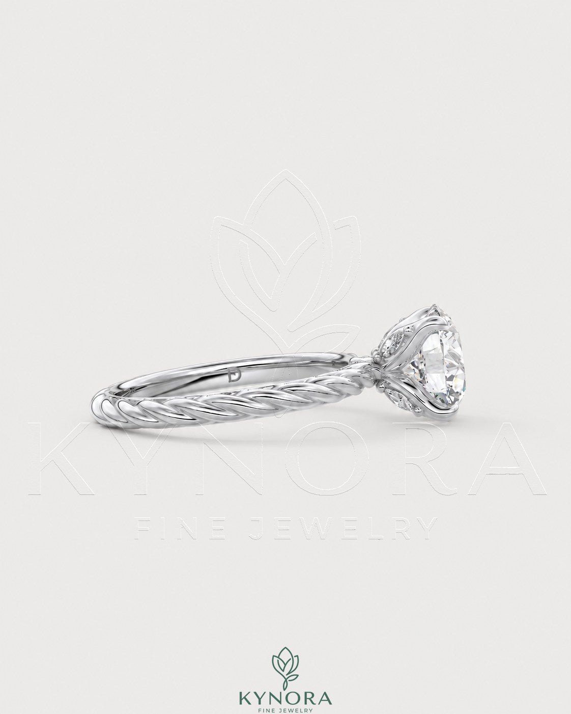 Round moissanite solitaire engagement ring with twisted silver shank, crafted by Kynora CJ, featuring a sparkling central stone.