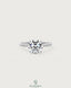 Round moissanite solitaire engagement ring with twisted silver shank by Kynora CJ, featuring a sparkling central stone.