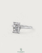 Radiant cut moissanite solitaire engagement ring in sterling silver featuring a prominent central stone and elegant band design.
