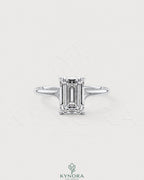 Emerald cut moissanite solitaire engagement ring in 925 sterling silver with a sleek band and sparkling center stone.