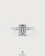 Emerald cut moissanite solitaire engagement ring in 925 sterling silver with a sleek band and sparkling center stone.